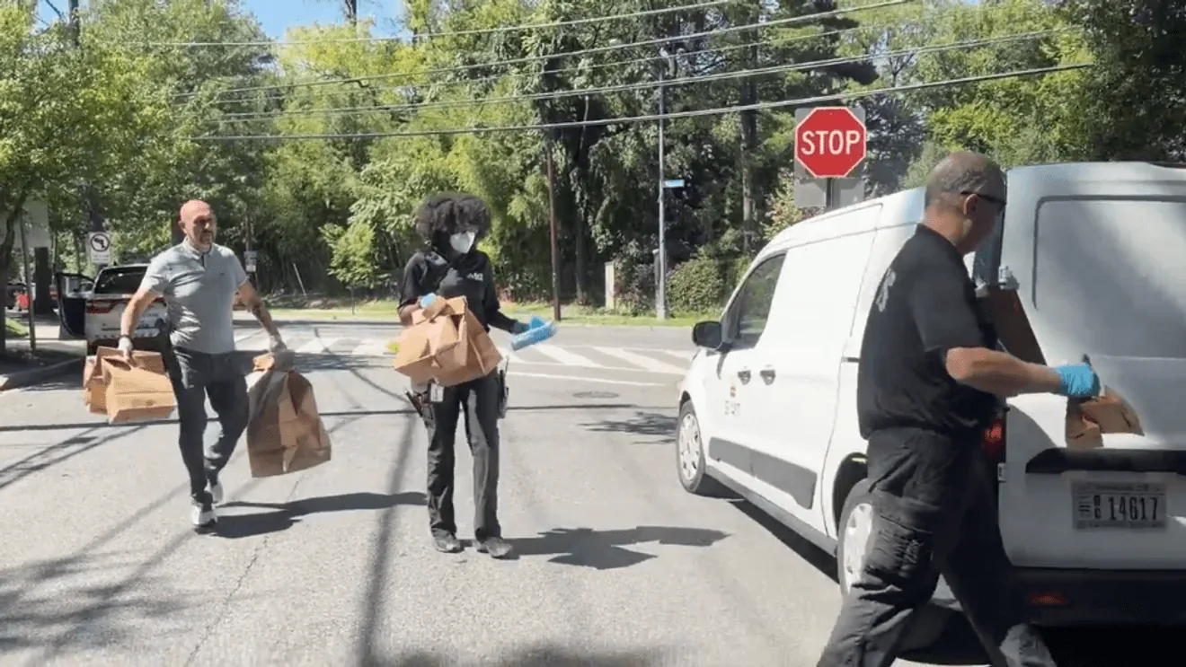 Investigators carry bags from a Northwest Washington home linked to missing mother Antoinette Forbes